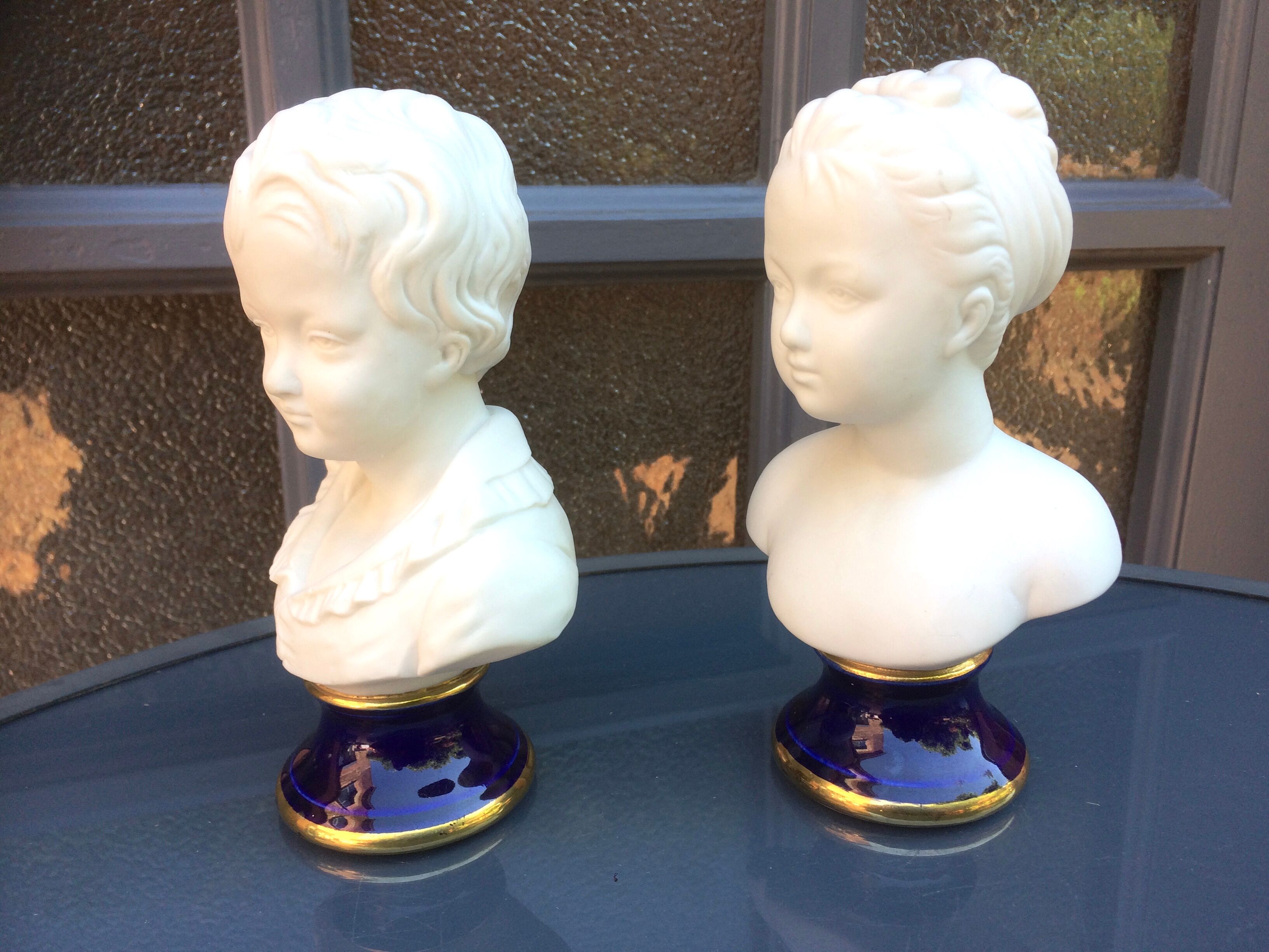 Children's busts in biscuit