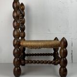 Brutalist wood turned bobbin low rush chair in the style of Charles Dudouyt