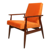Modern armchair in orange papaya velvet with dark brown wood, 1970s Scandinavian style.