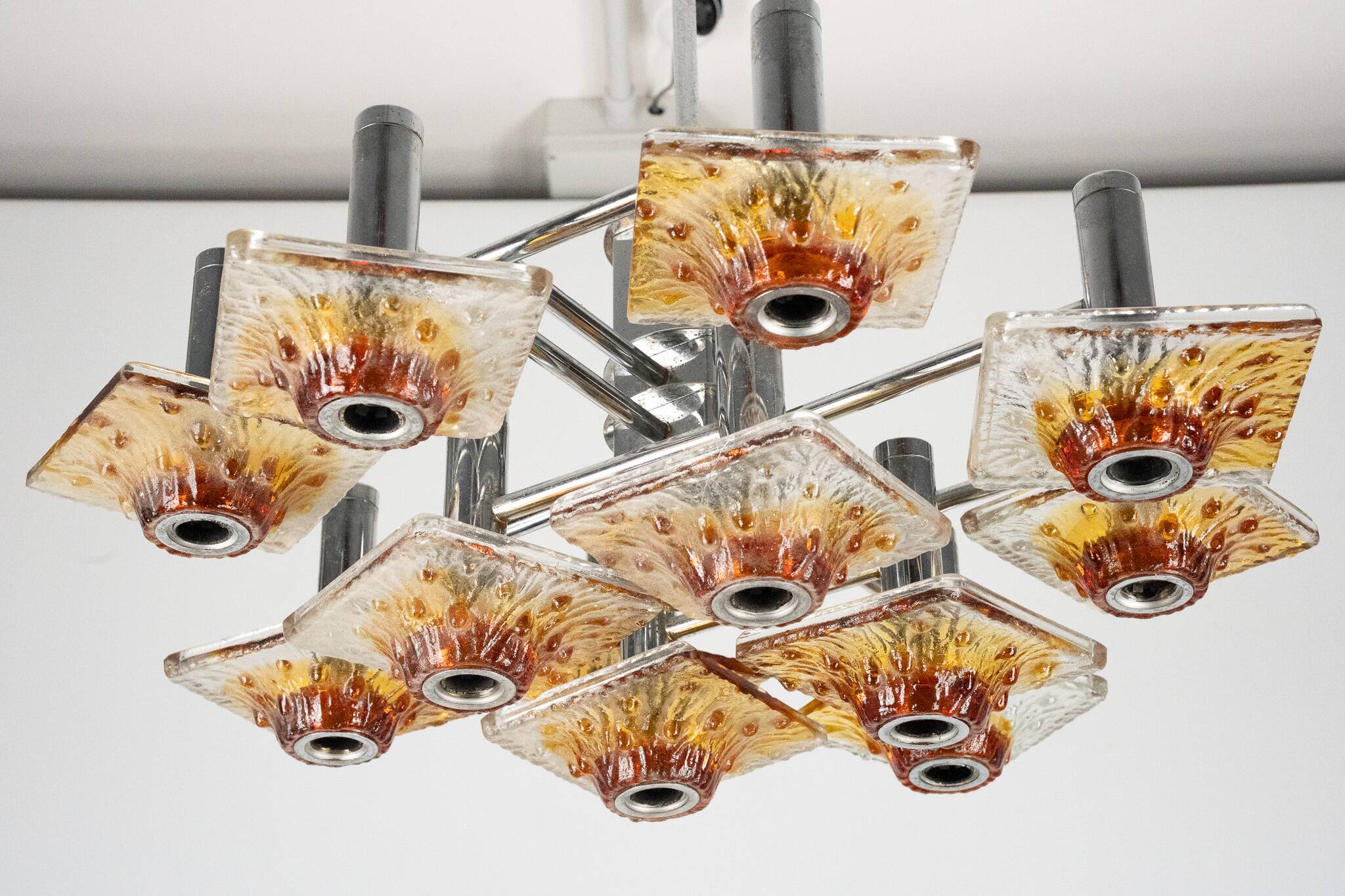 12-light Mazzega chandelier in amber and clear murano glass and chrome. Ita