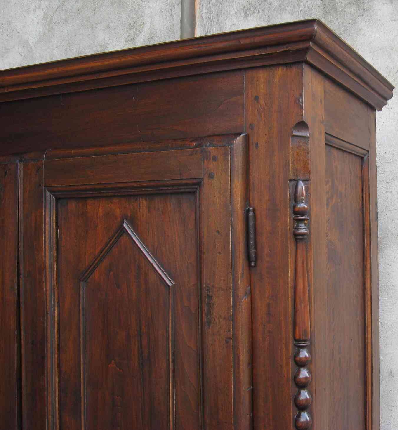 Antique solid wood wardrobe in historical rustic style from the 19th century.