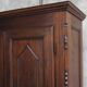Antique solid wood wardrobe in historical rustic style from the 19th century.