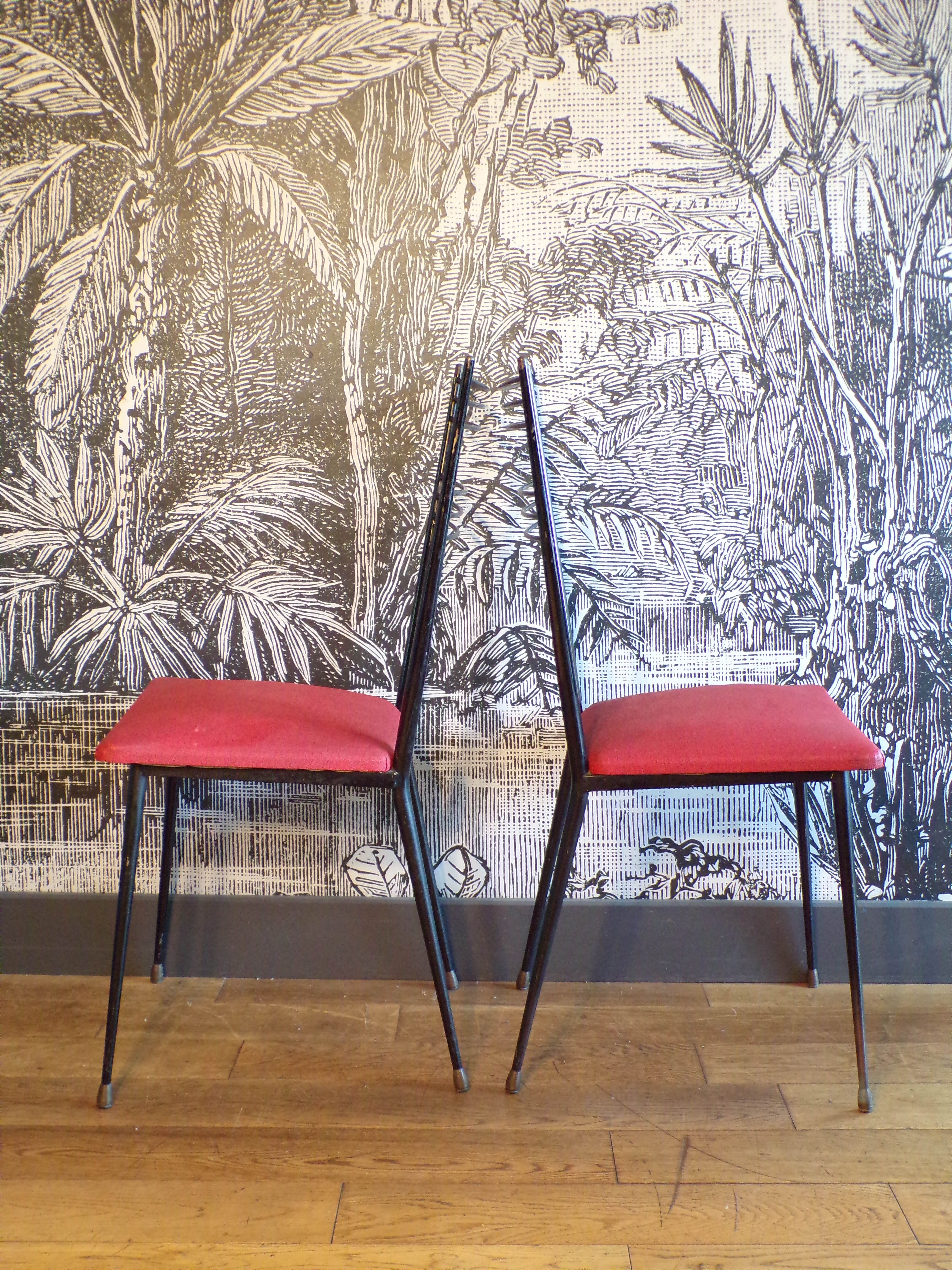 Pair of red Colette Guéden chairs
