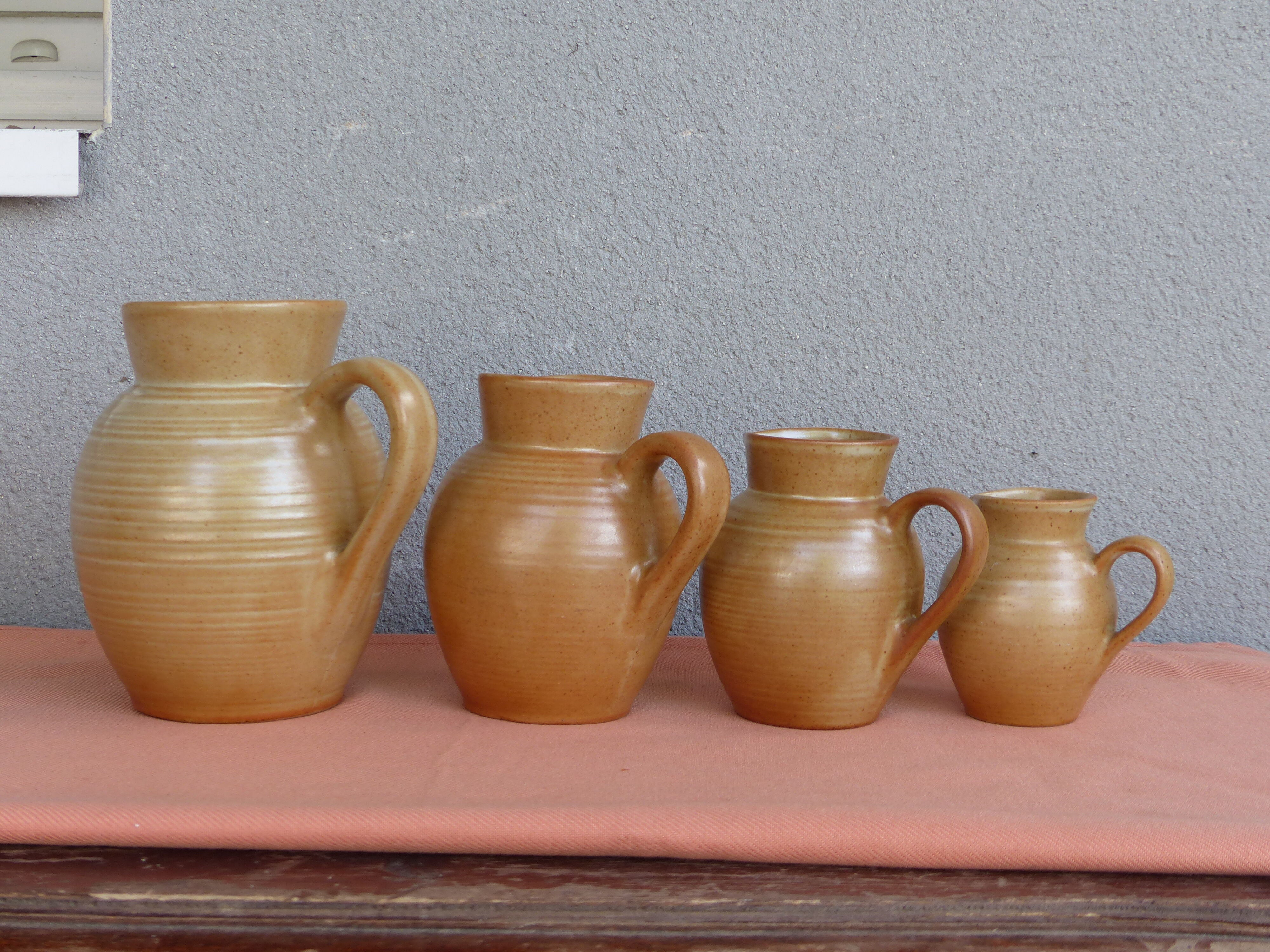 Set of 4 pitchers, CNP, Grès Village France.