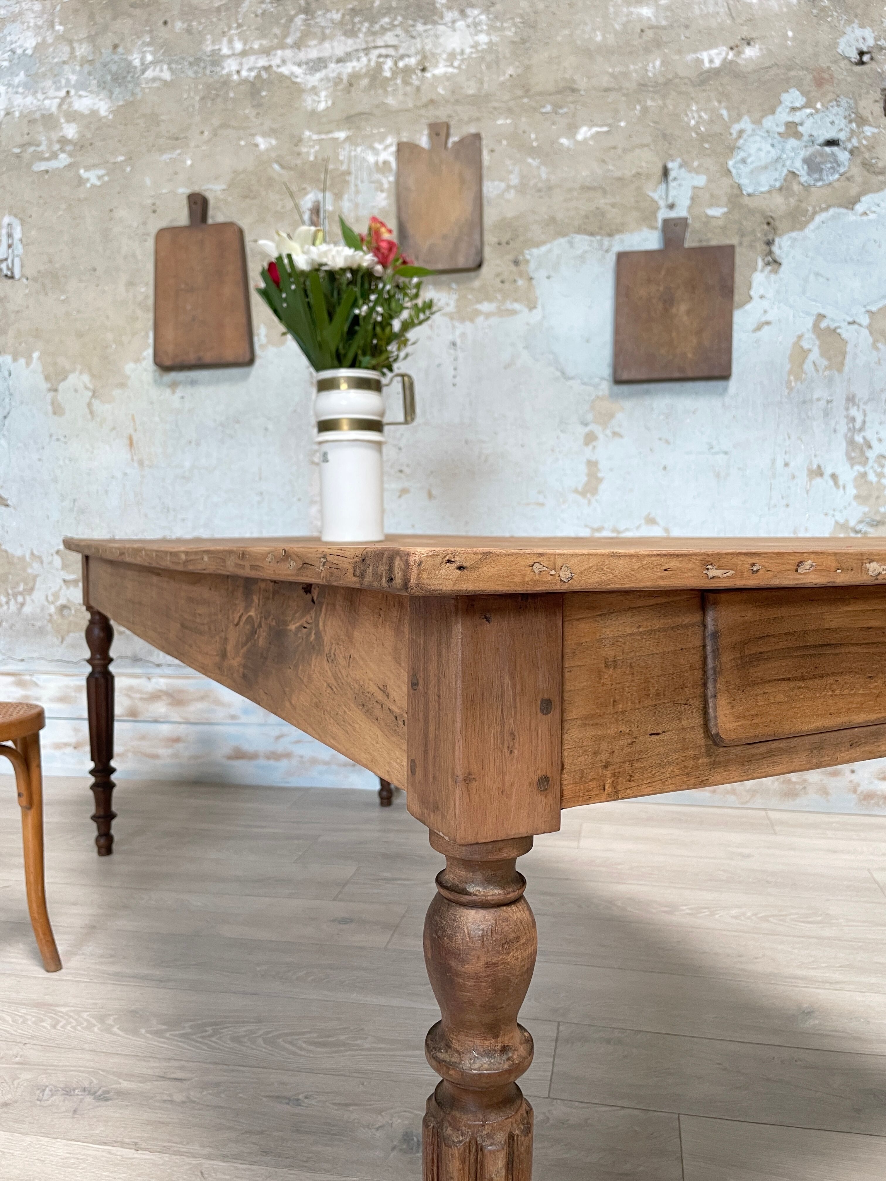 Vintage farmhouse table with turned legs.