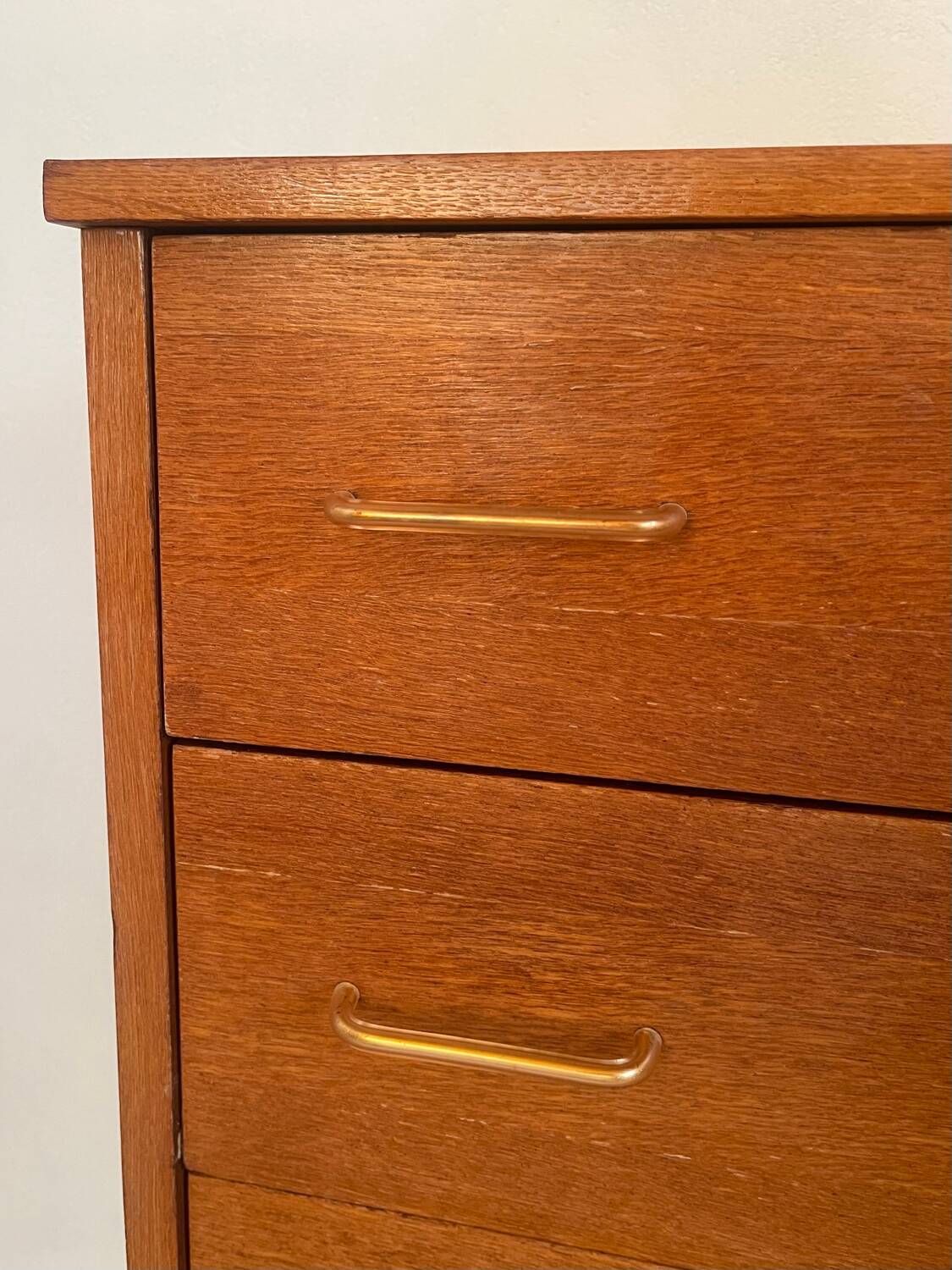 Vintage 1960s chest of drawers with covered handles.