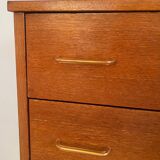 Vintage 1960s chest of drawers with covered handles.