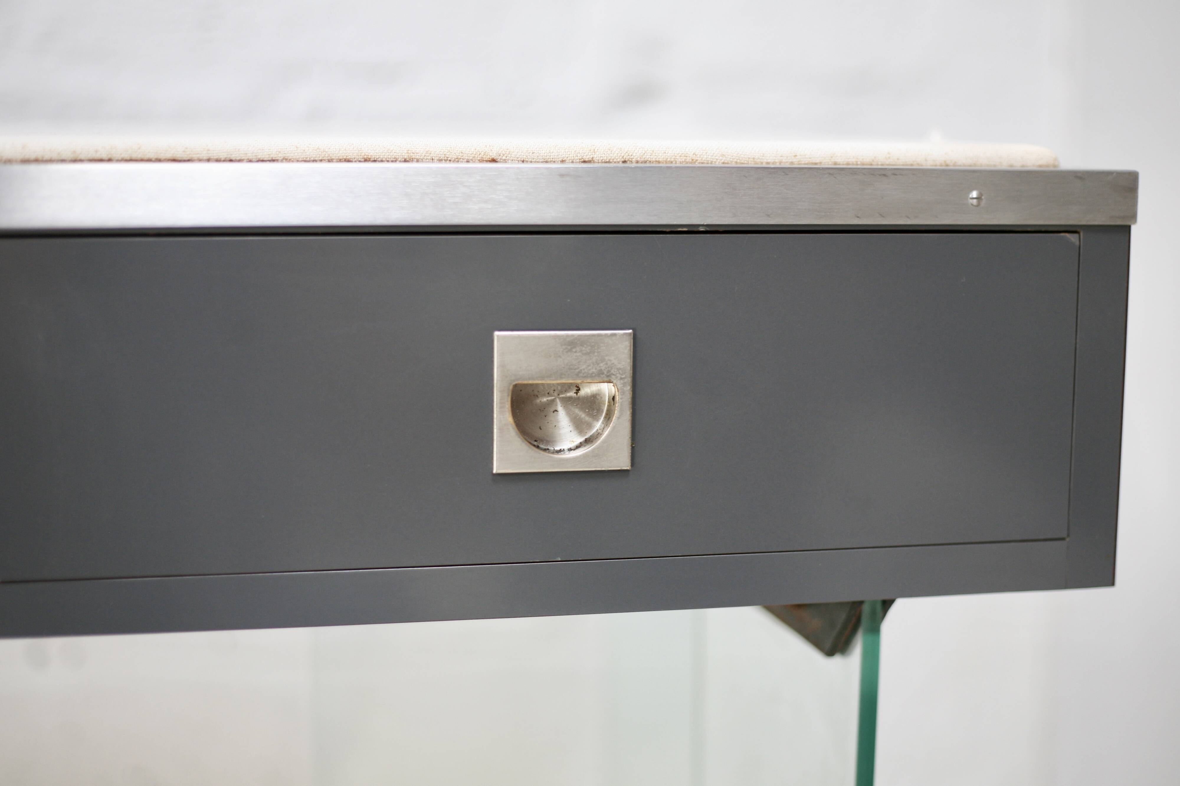 Modernist console, 1960s, glass base, wooden and fabric top.