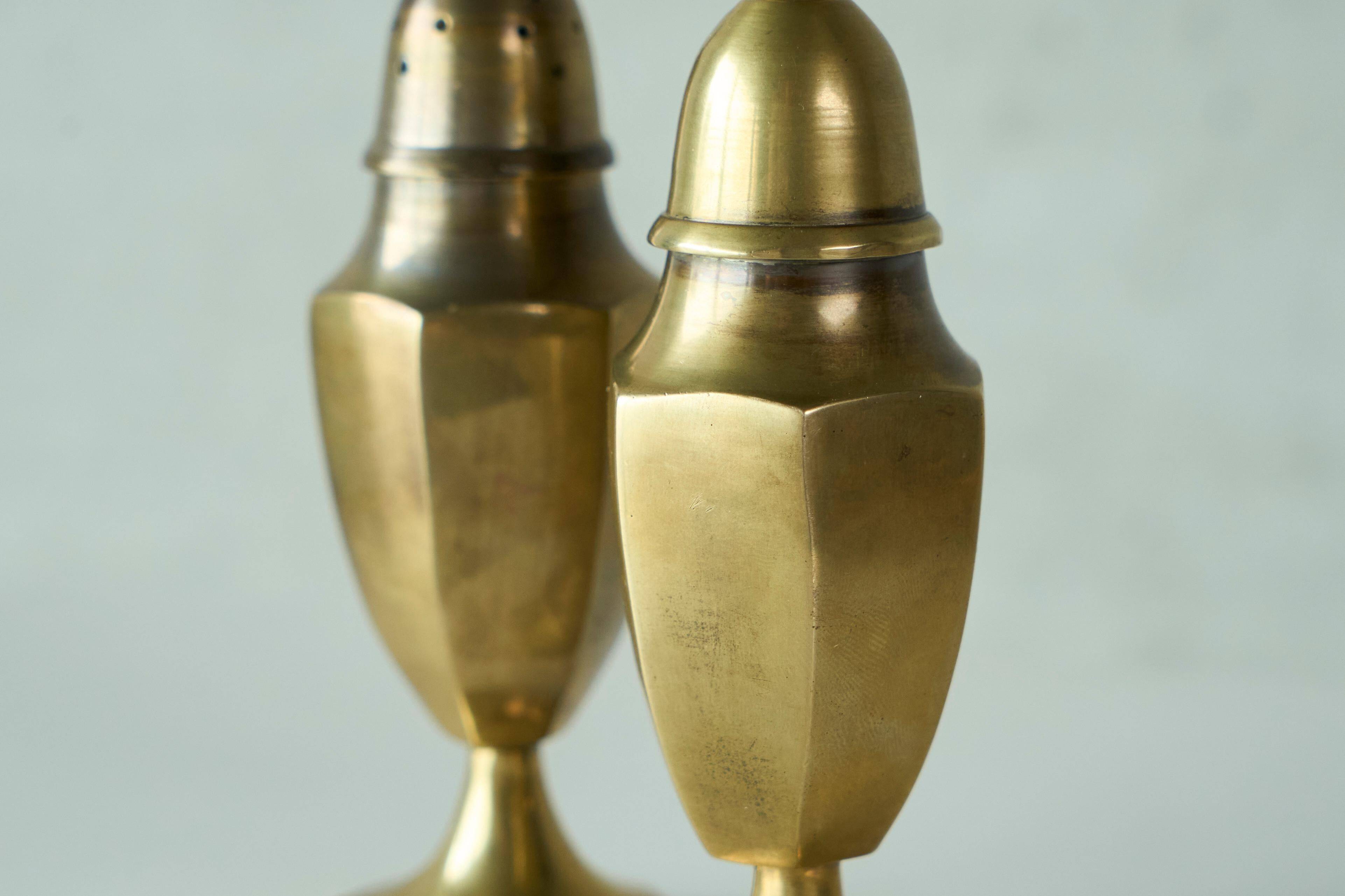 Pair of patinated brass salt and pepper shakers, 20th century.