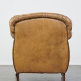 Fauteuil ancien en cuir de mouton