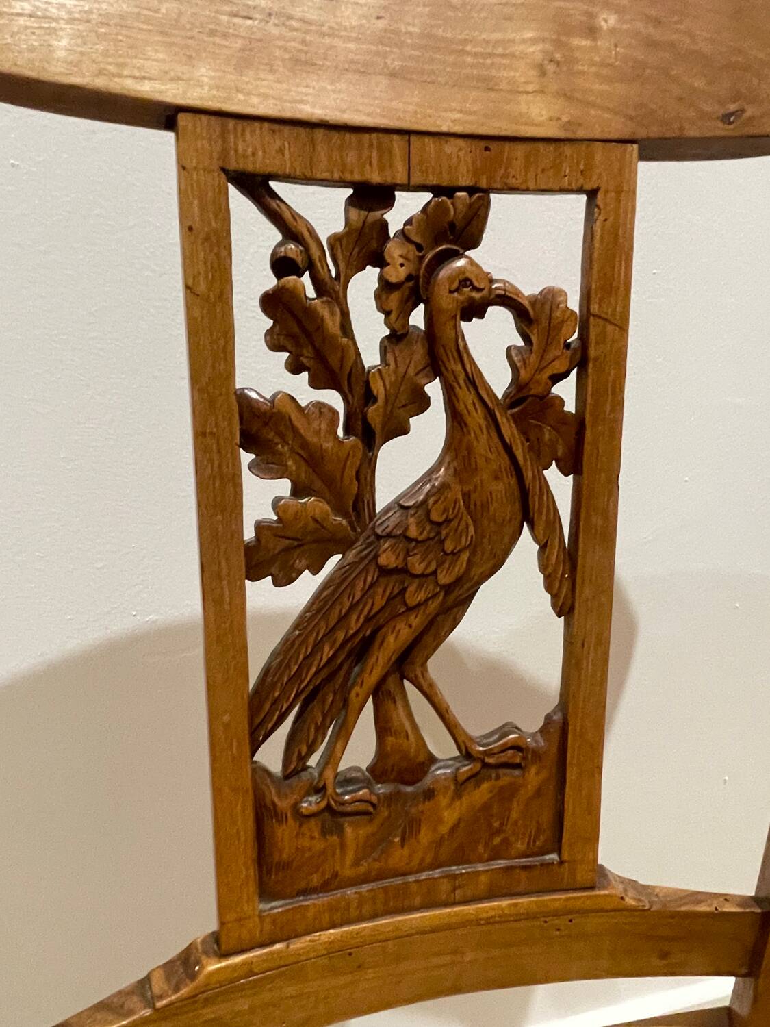 19th century straw chair with carved peacock back