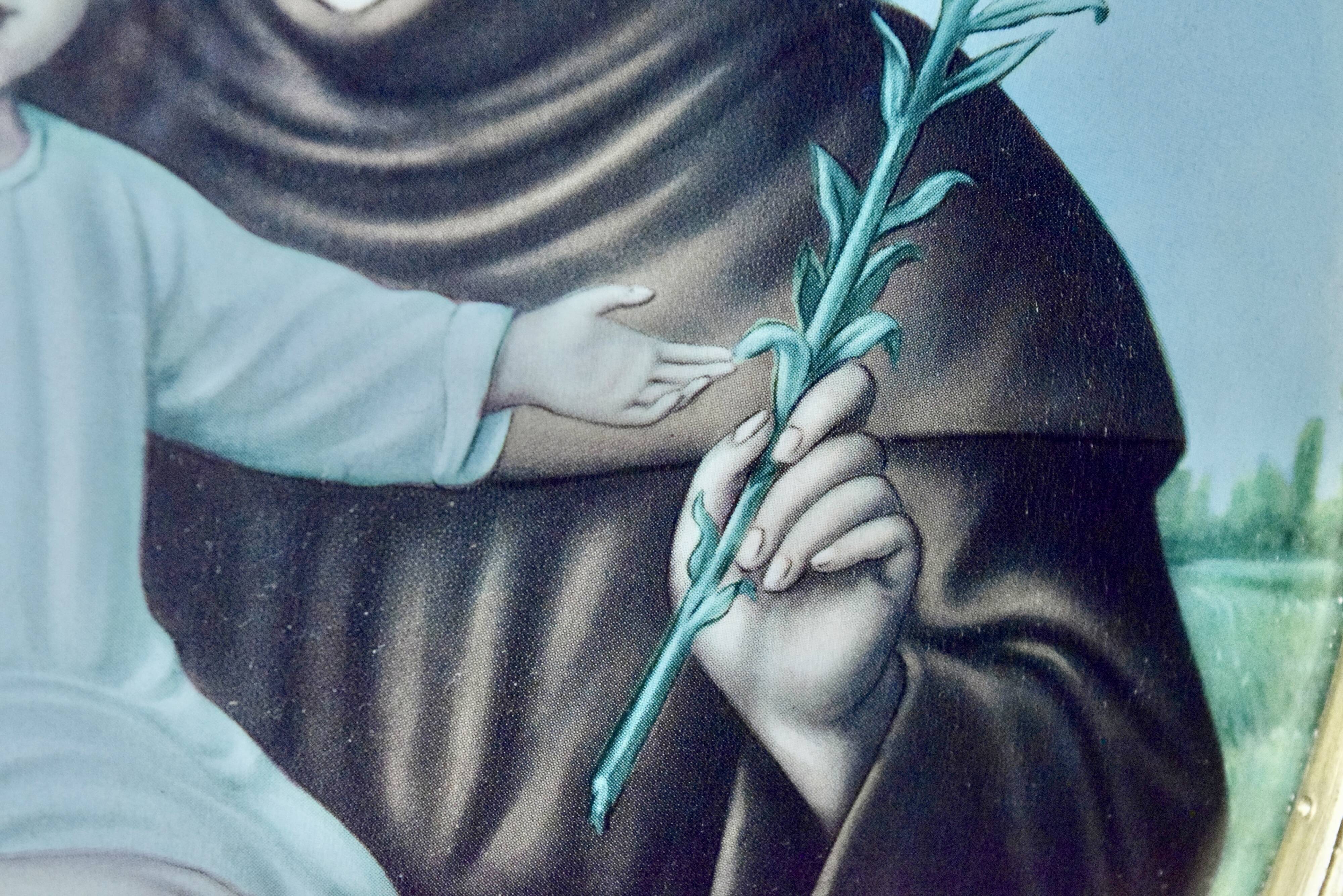 Old religious light frame in gilded stucco and curved glass