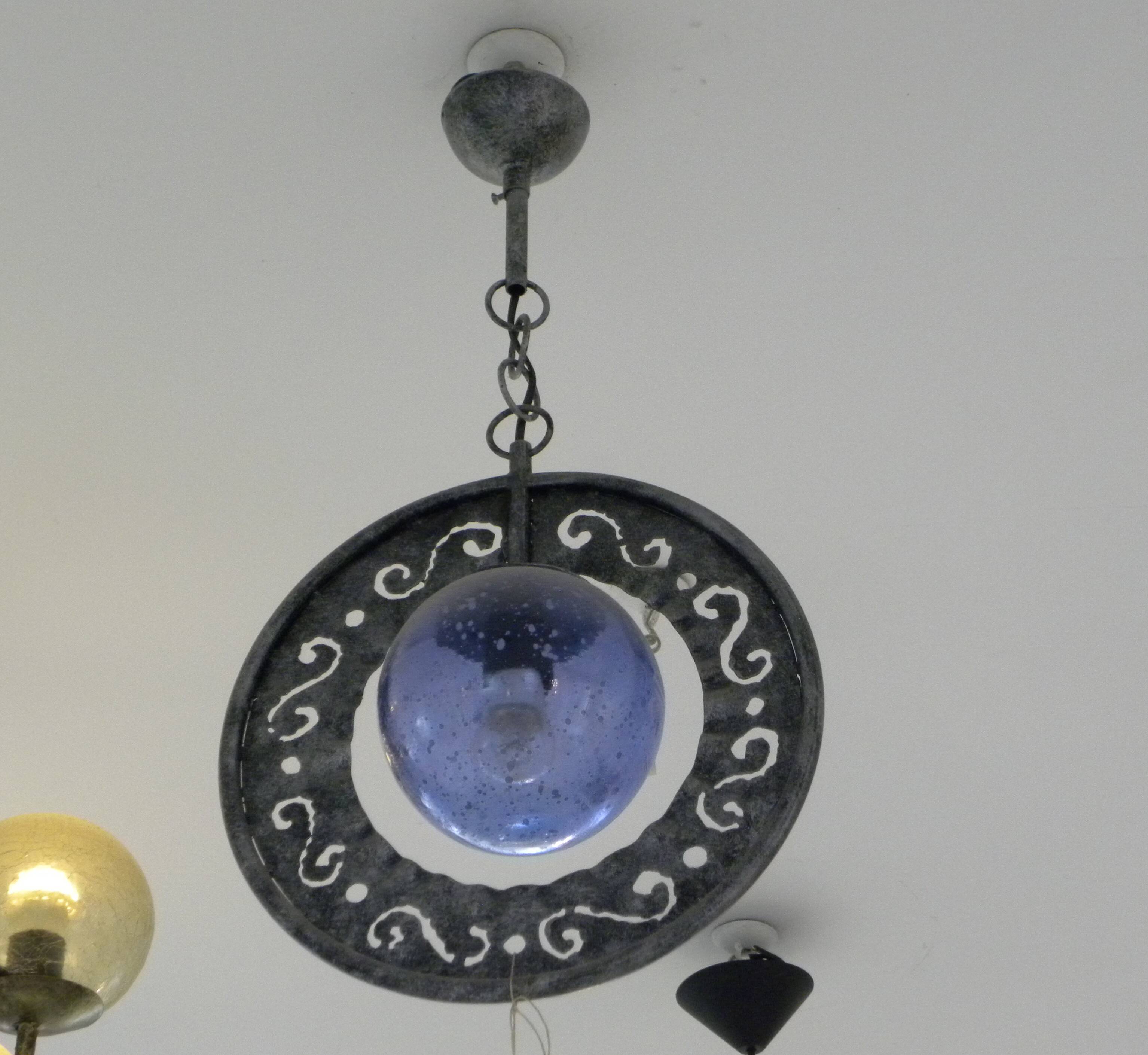 Patinated metal chandelier with cobalt blue blown glass in a rustic style.