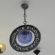Patinated metal chandelier with cobalt blue blown glass in a rustic style.