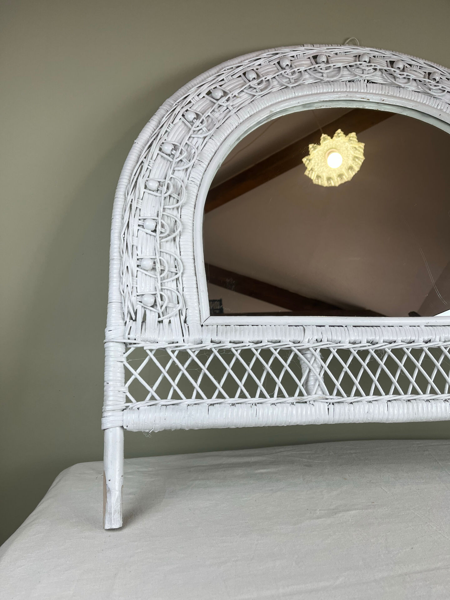 Half-moon wicker mirror