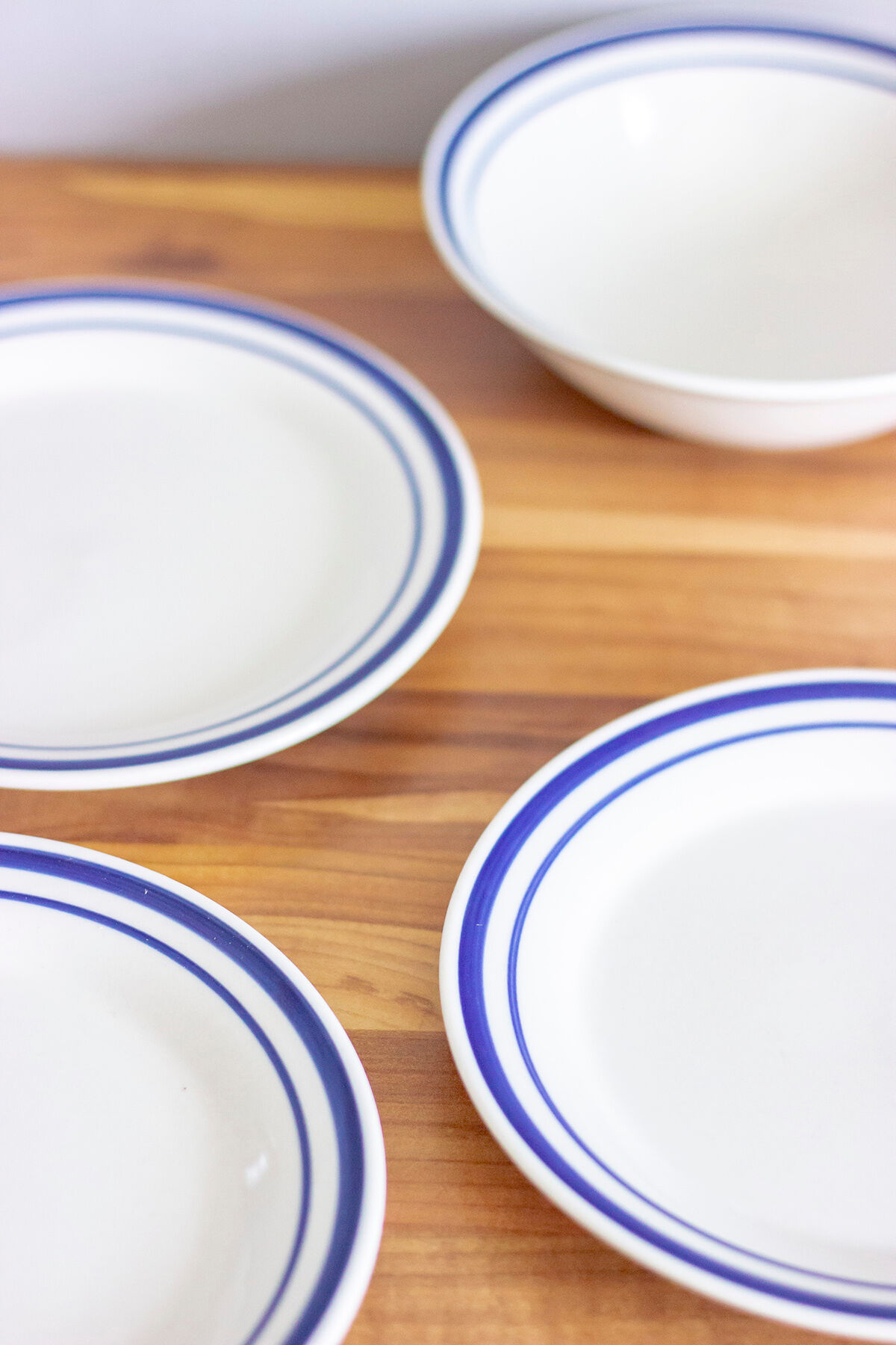 4 blue bordered dessert plates and a matching bowl