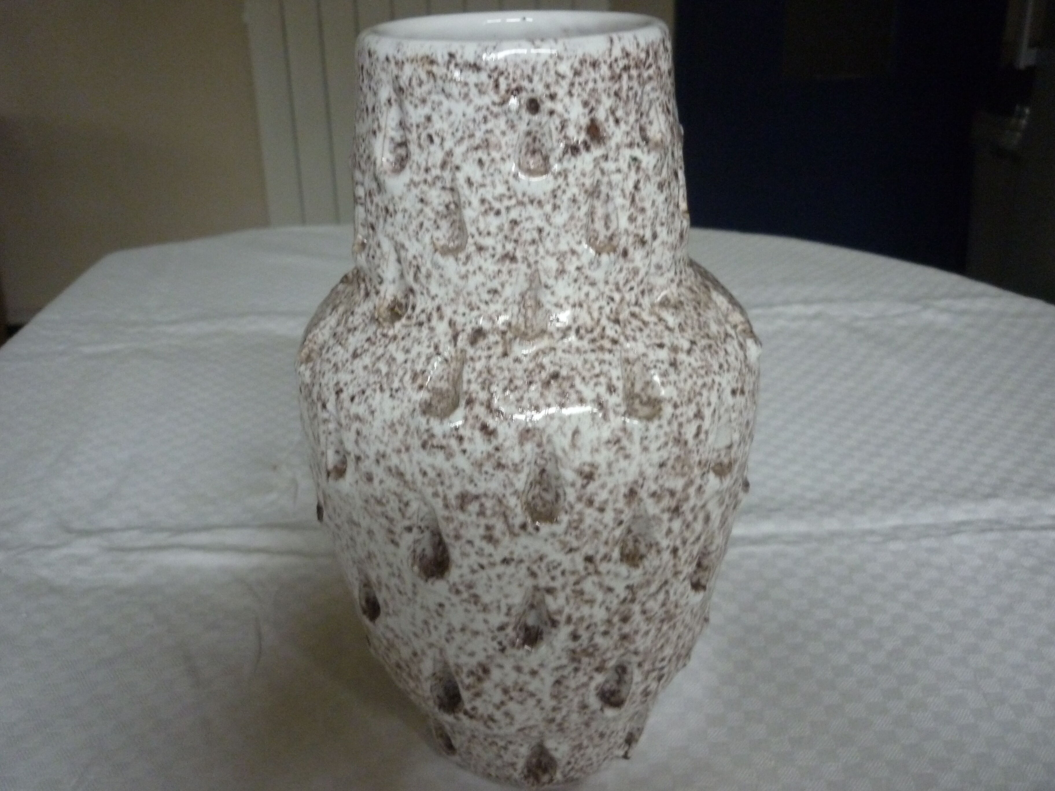 Spotted white ceramic vase with hollow form of tears