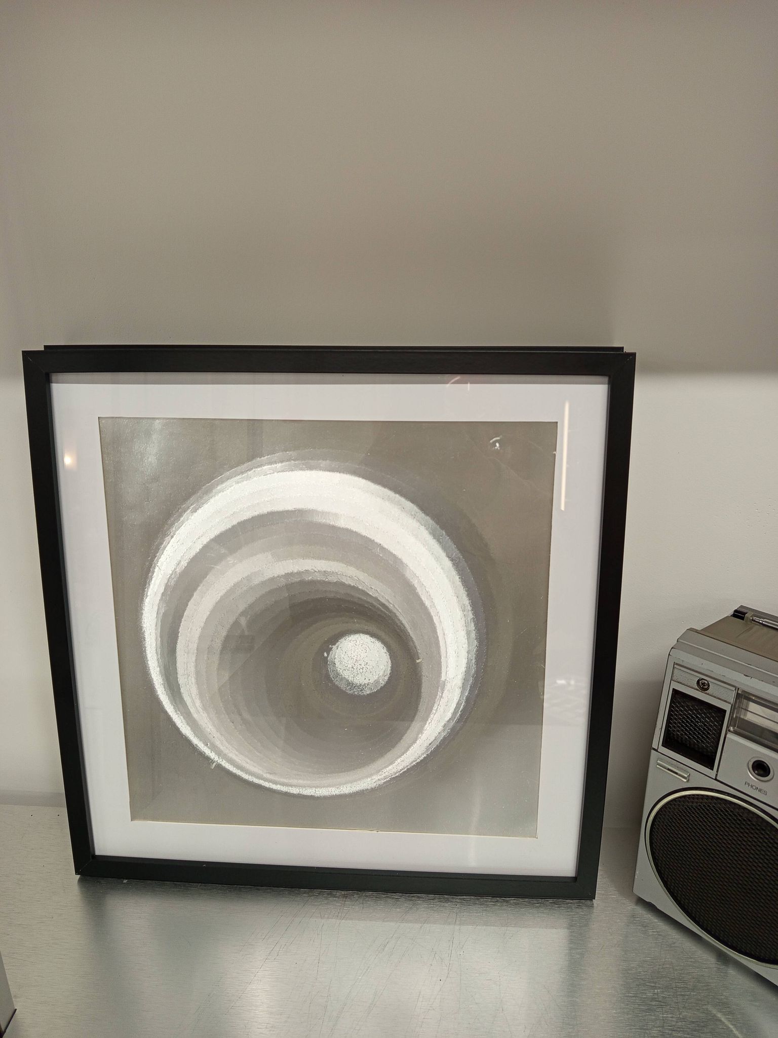 a Kinetic Op Art Aluchromy under glass frame.