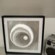 a Kinetic Op Art Aluchromy under glass frame.