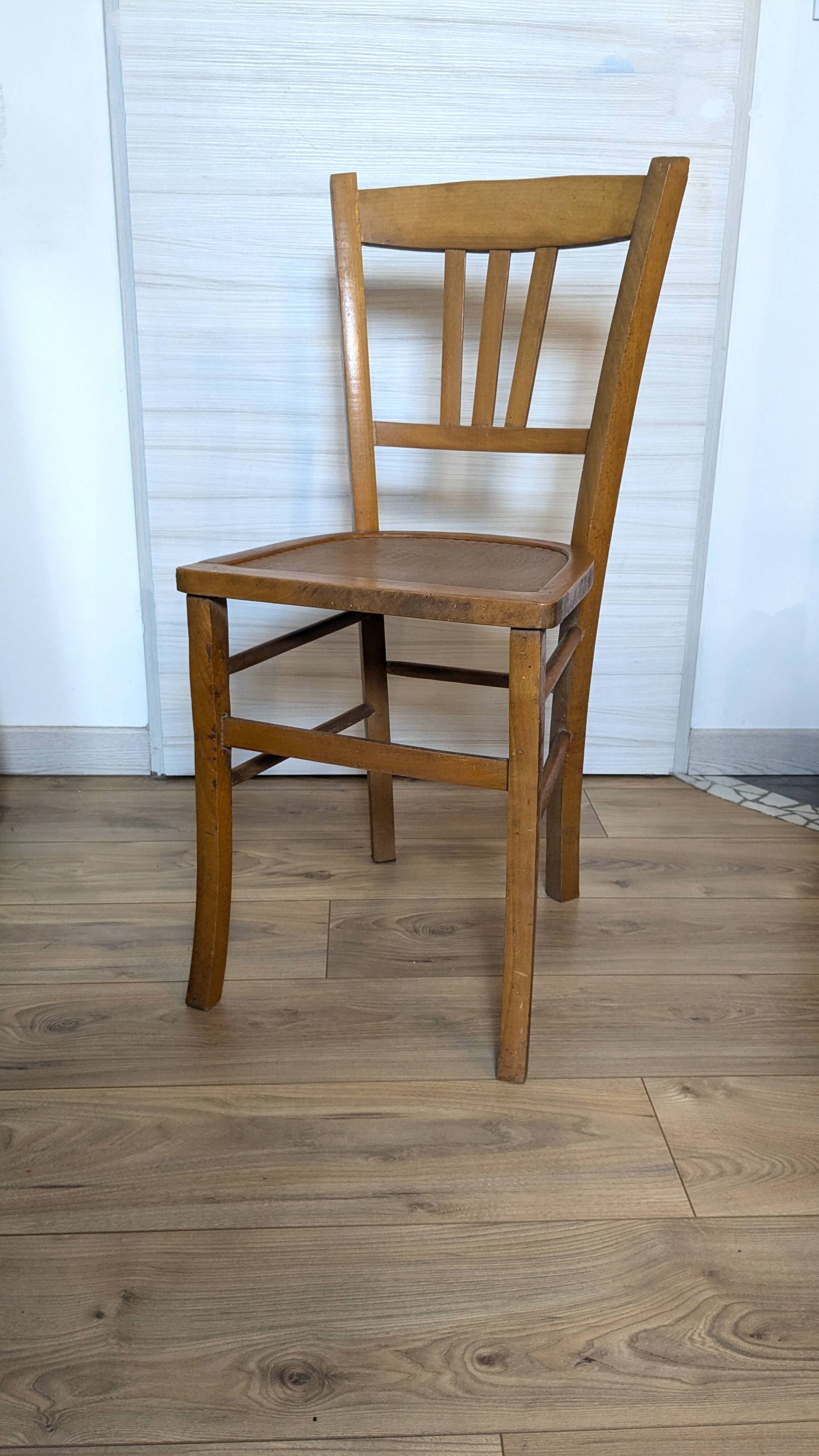 Antique patinated wooden bistro chair from the early 20th century.