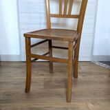 Antique patinated wooden bistro chair from the early 20th century.
