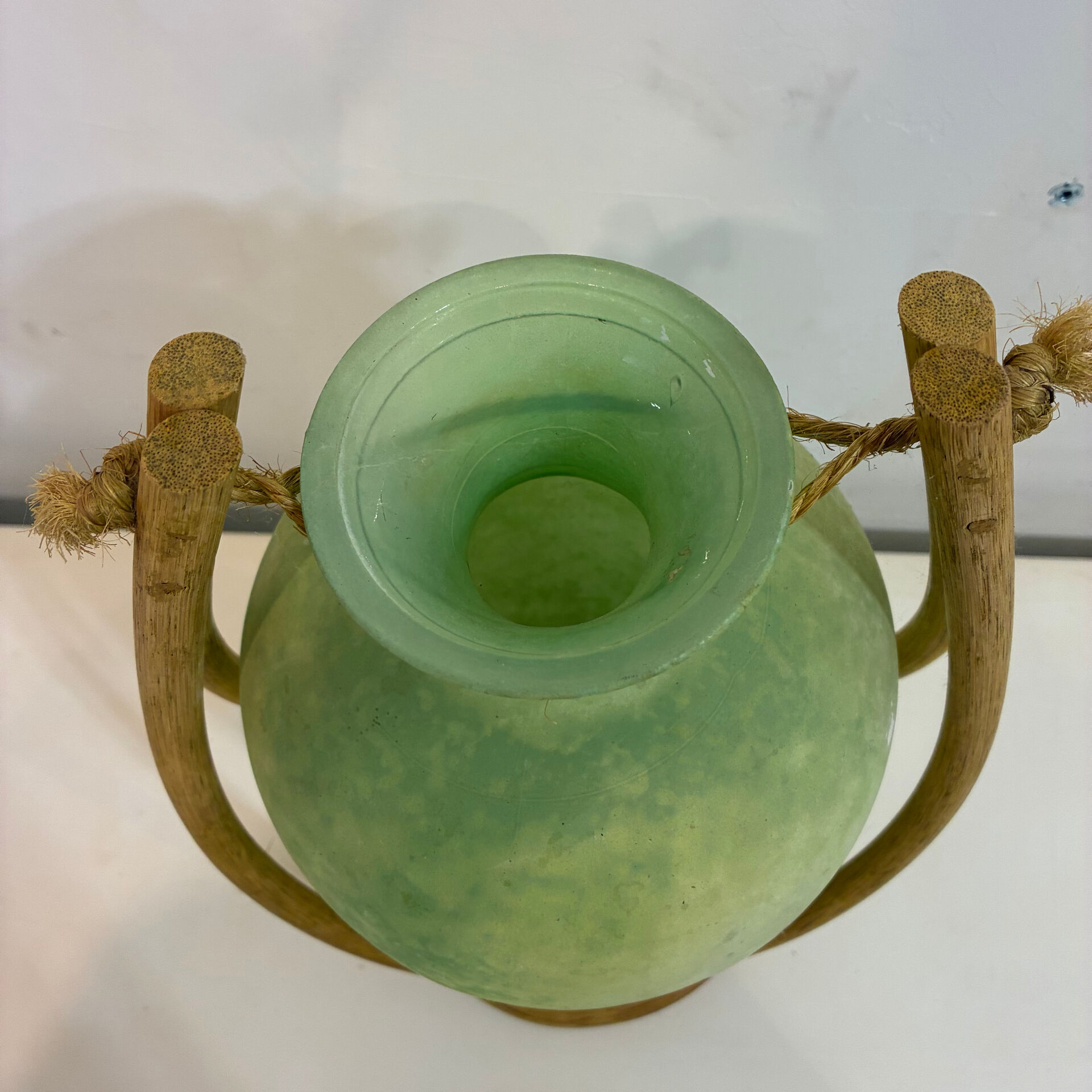 Rare glass paste amphora suspended in a wicker frame.