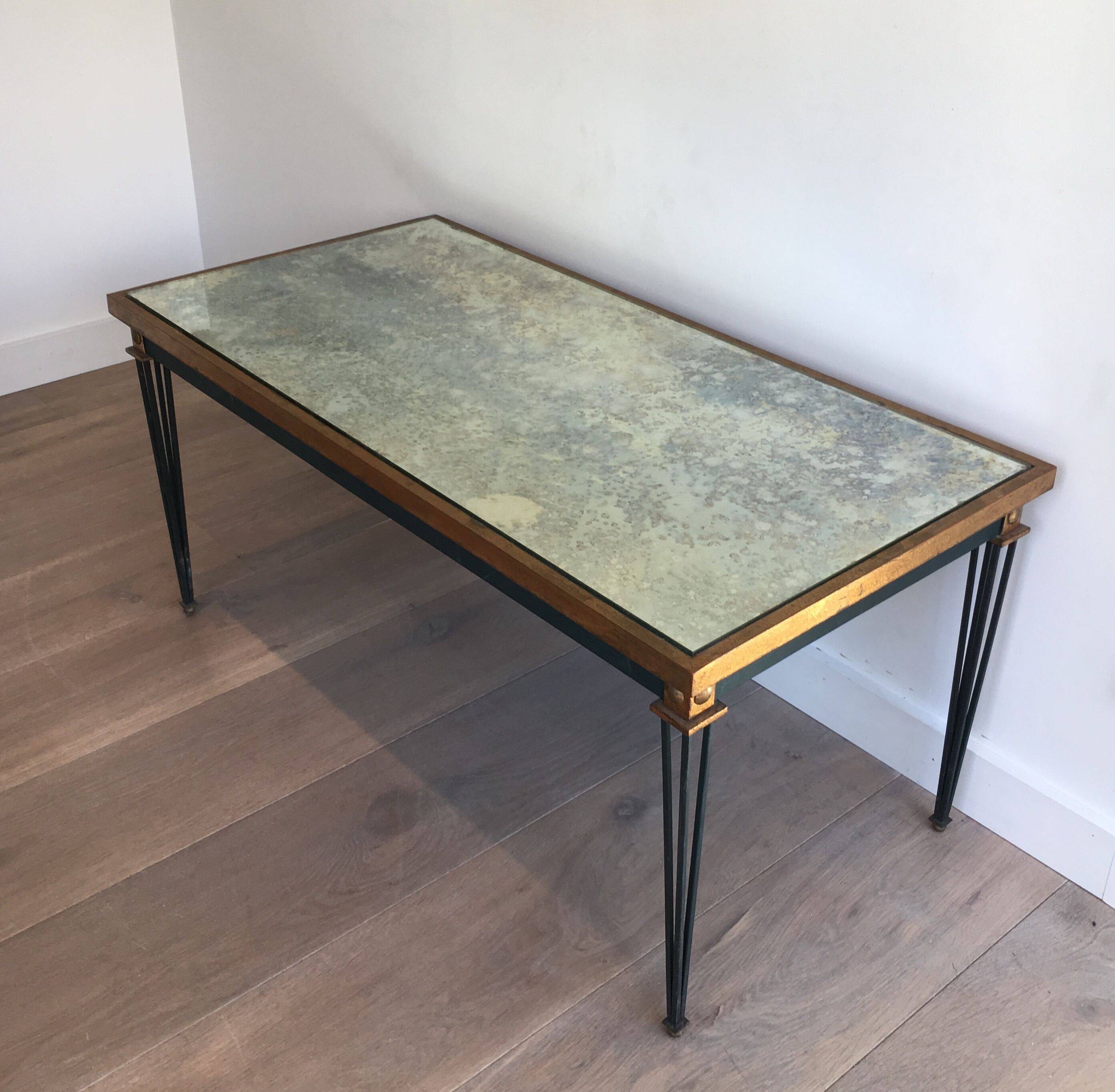 Patinated and gilded steel coffee table in the style of Jacques Quinet.
