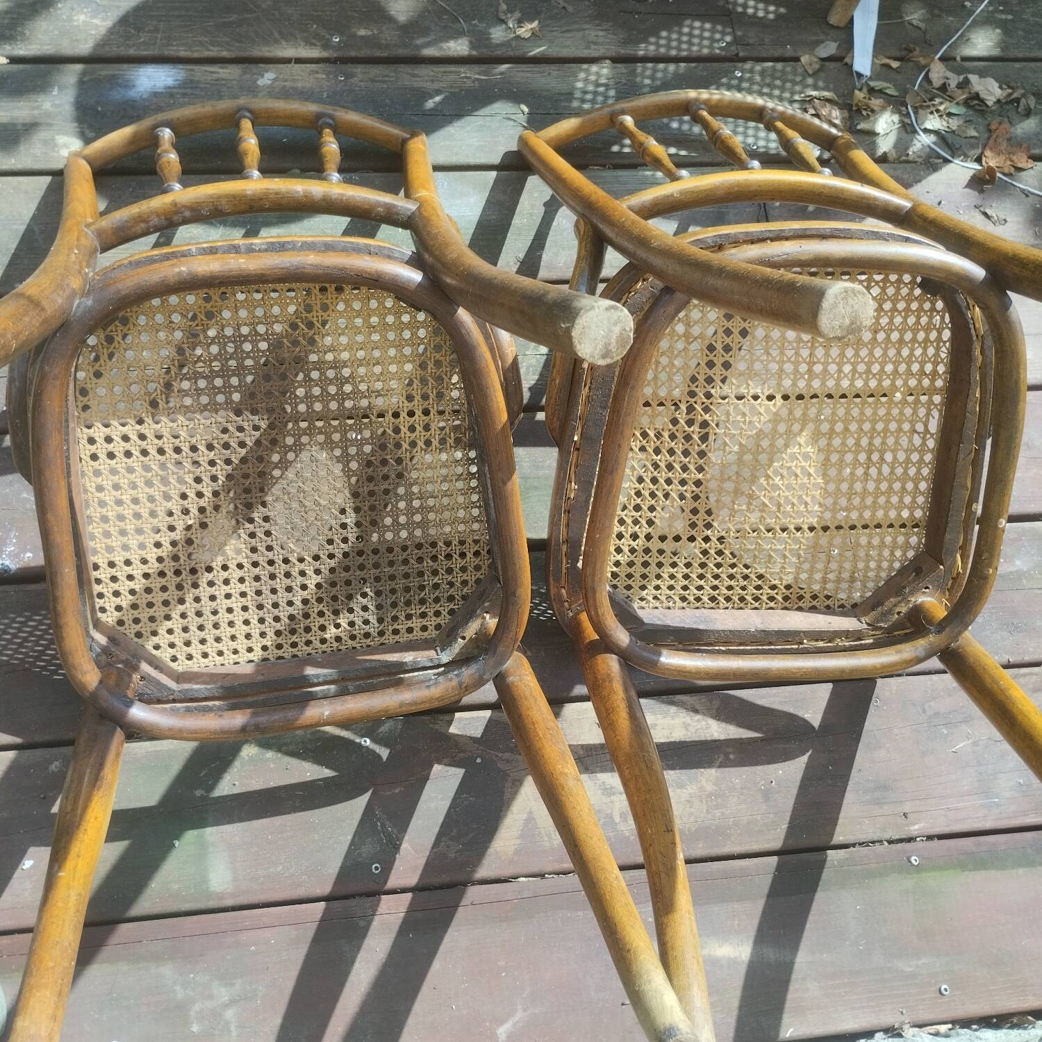 Set of 2 antique bistro chairs. Curved and turned wood.