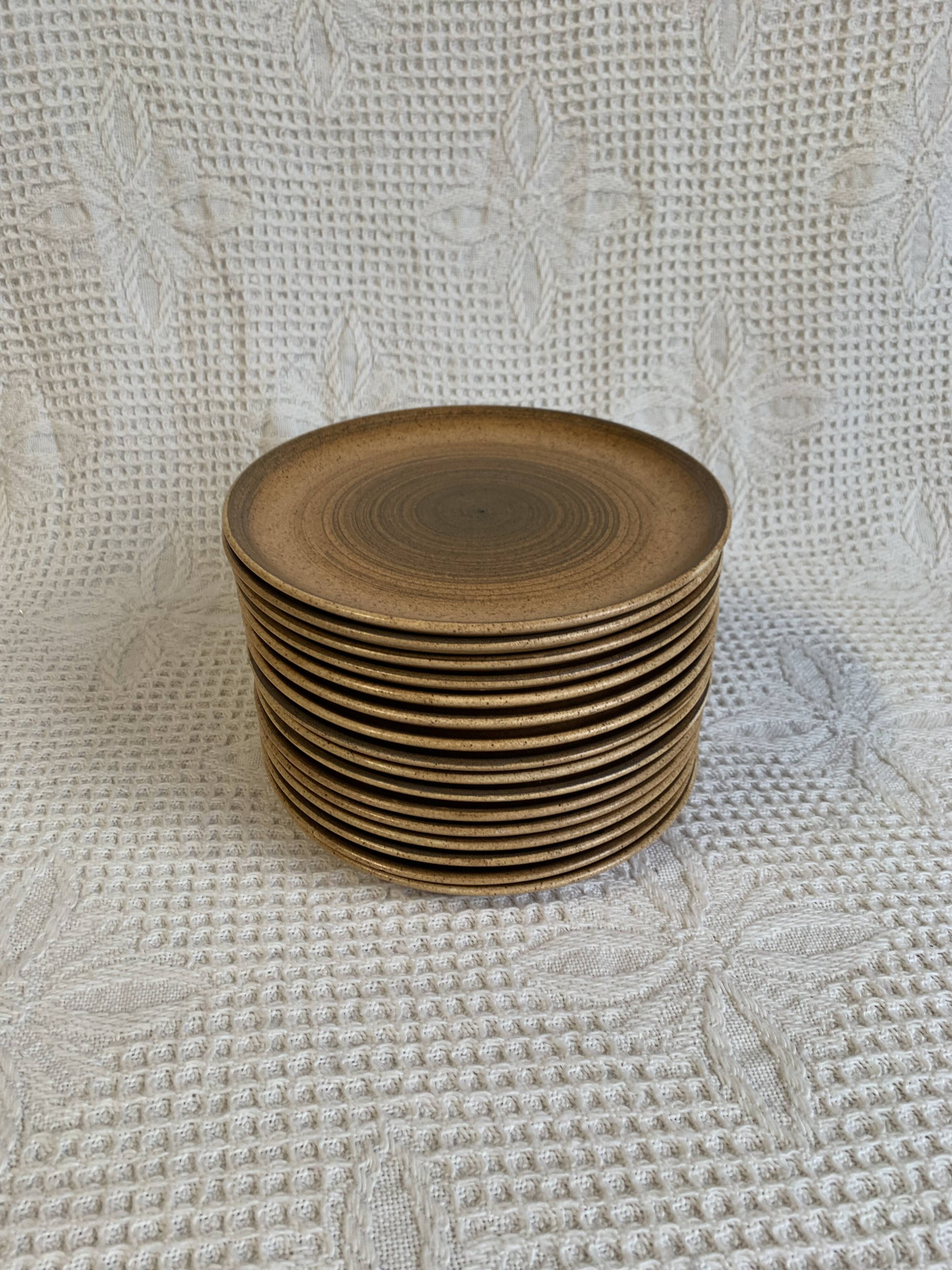 8 Longchamp enamelled stoneware plates, 1970