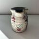 Floral decorated pitcher signed
