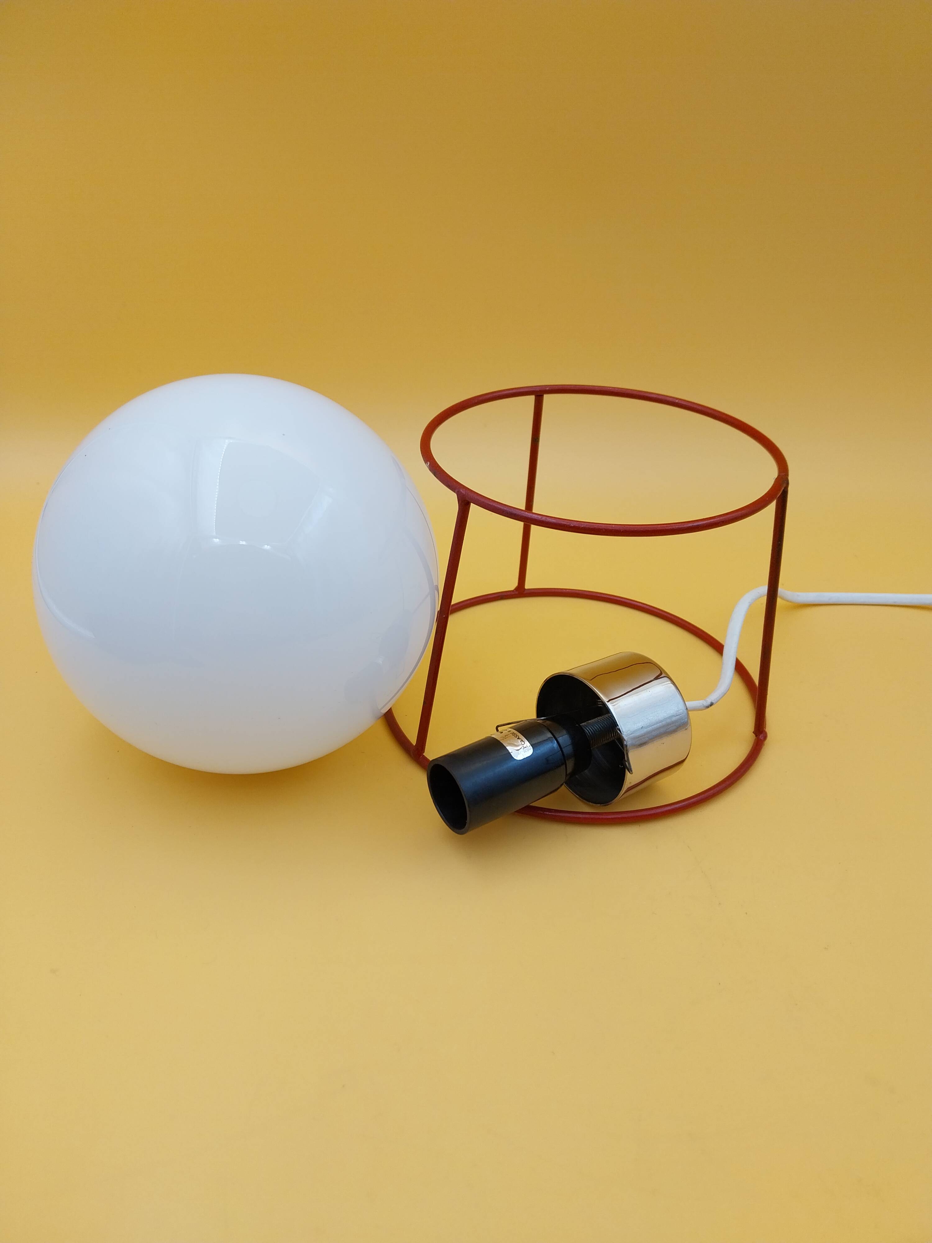 Red metal lamp with opaline globe from the 70s and 80s.