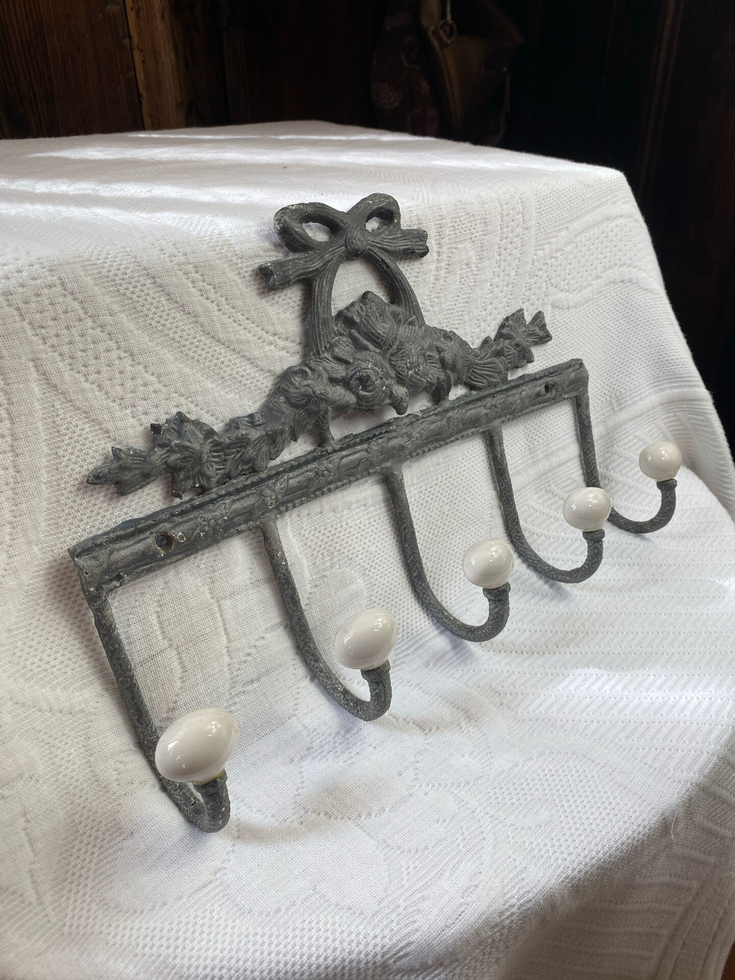 Patinated metal wall bracket and porcelain