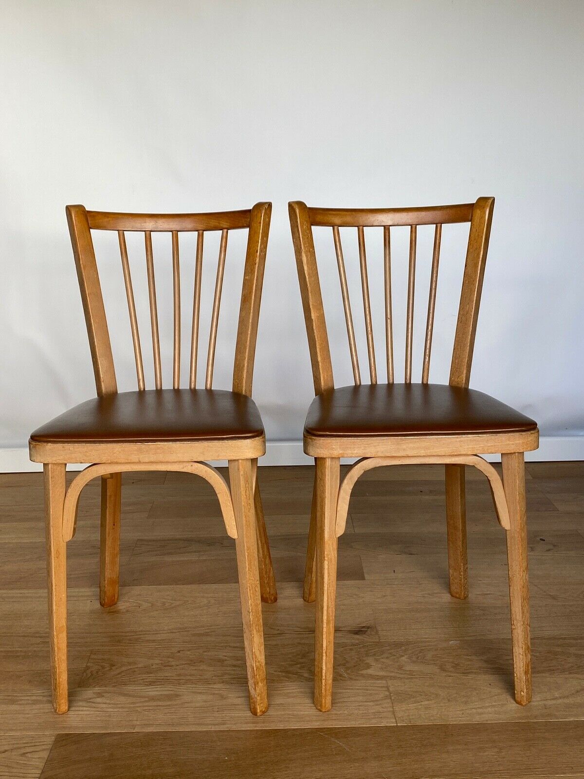 Four chairs Baumann 1960 with bars seated skaï brown label