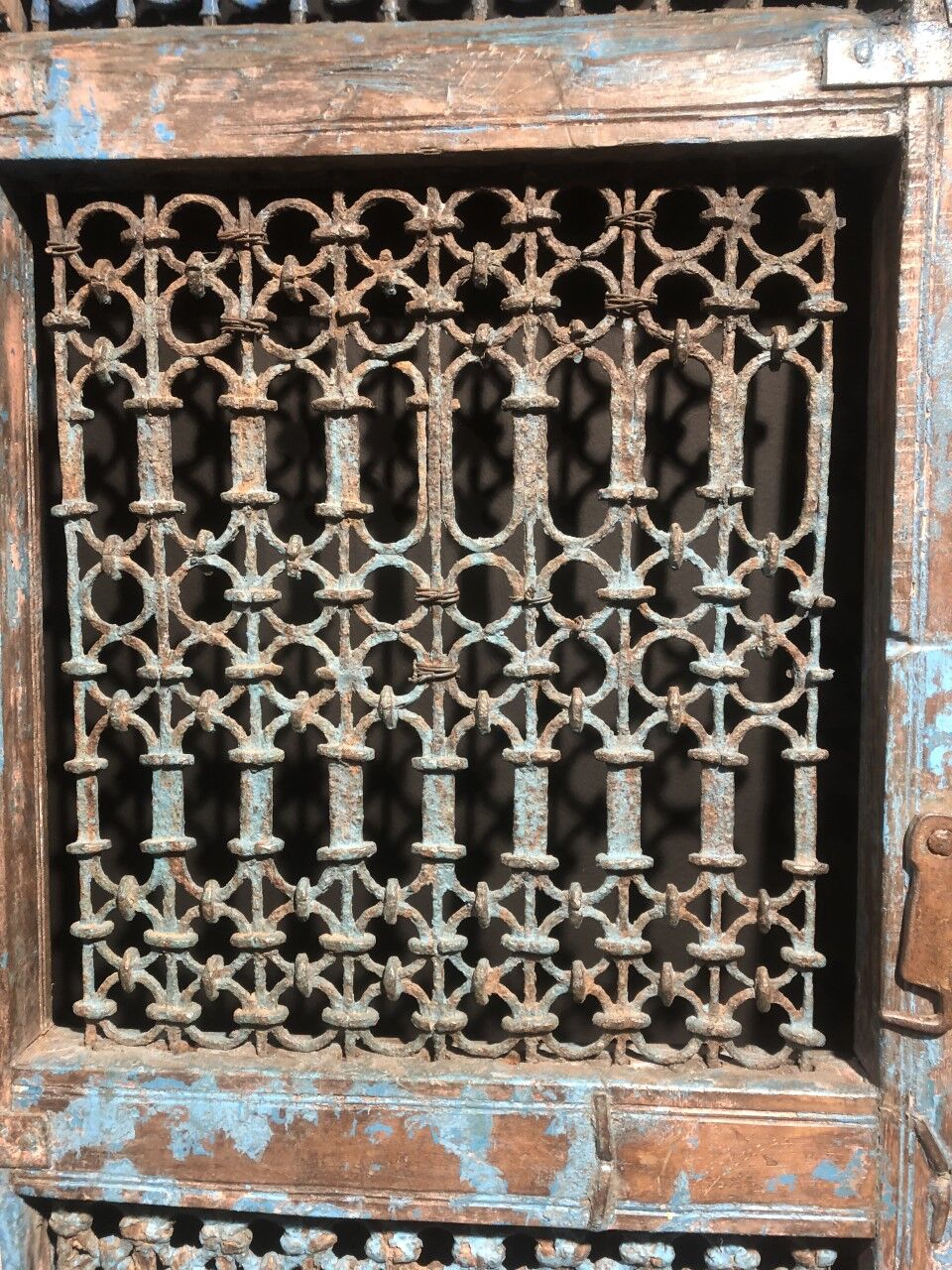 Openwork indian door in metal and blue wood