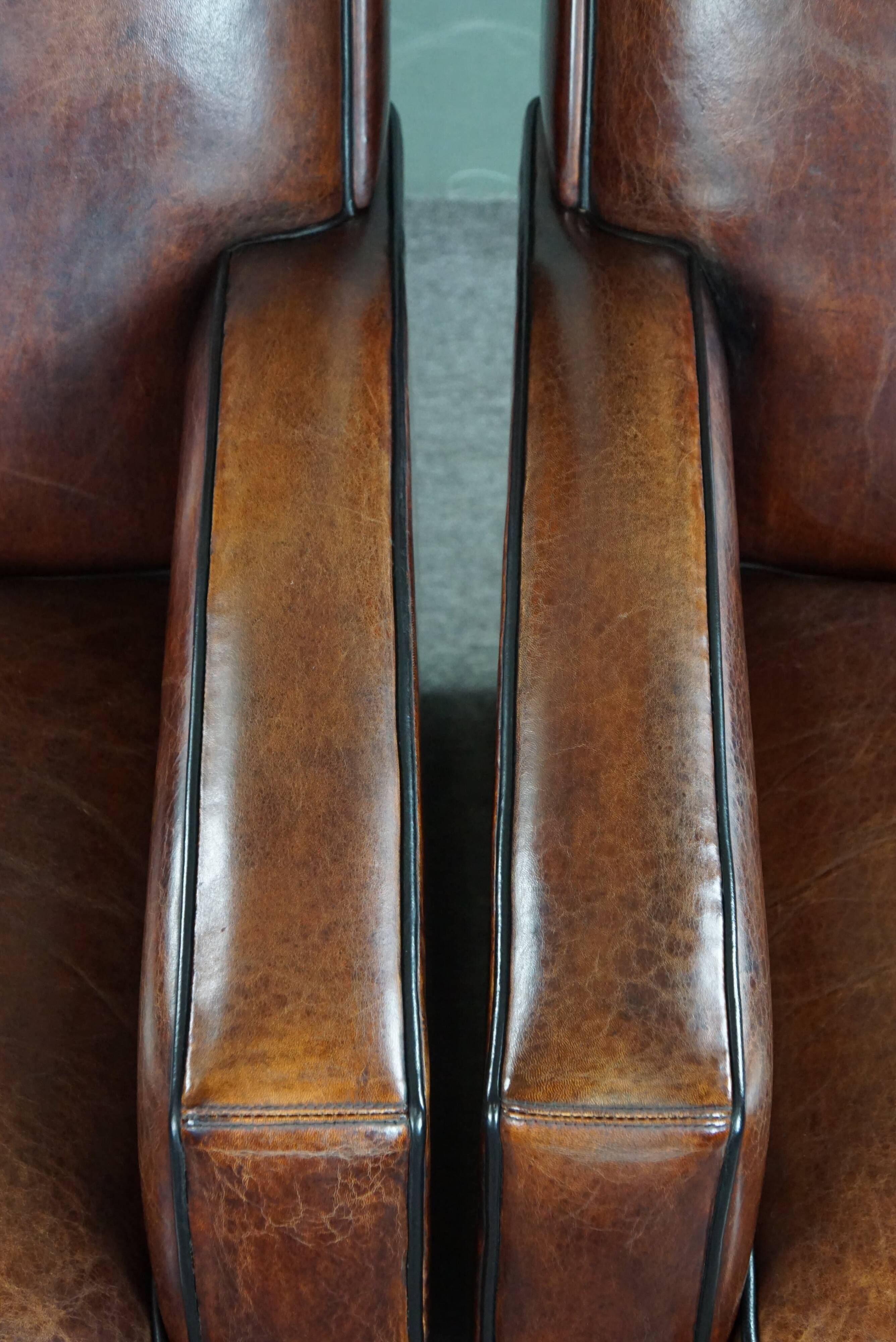 A very beautiful set of 2 Art Deco design armchairs in sheep leather