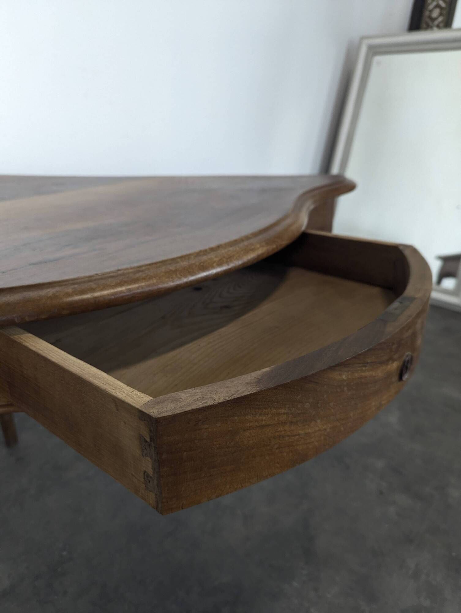 Louis XV corner table in walnut with curved legs.