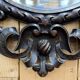 Oval mirror in carved wood with dragon heads.