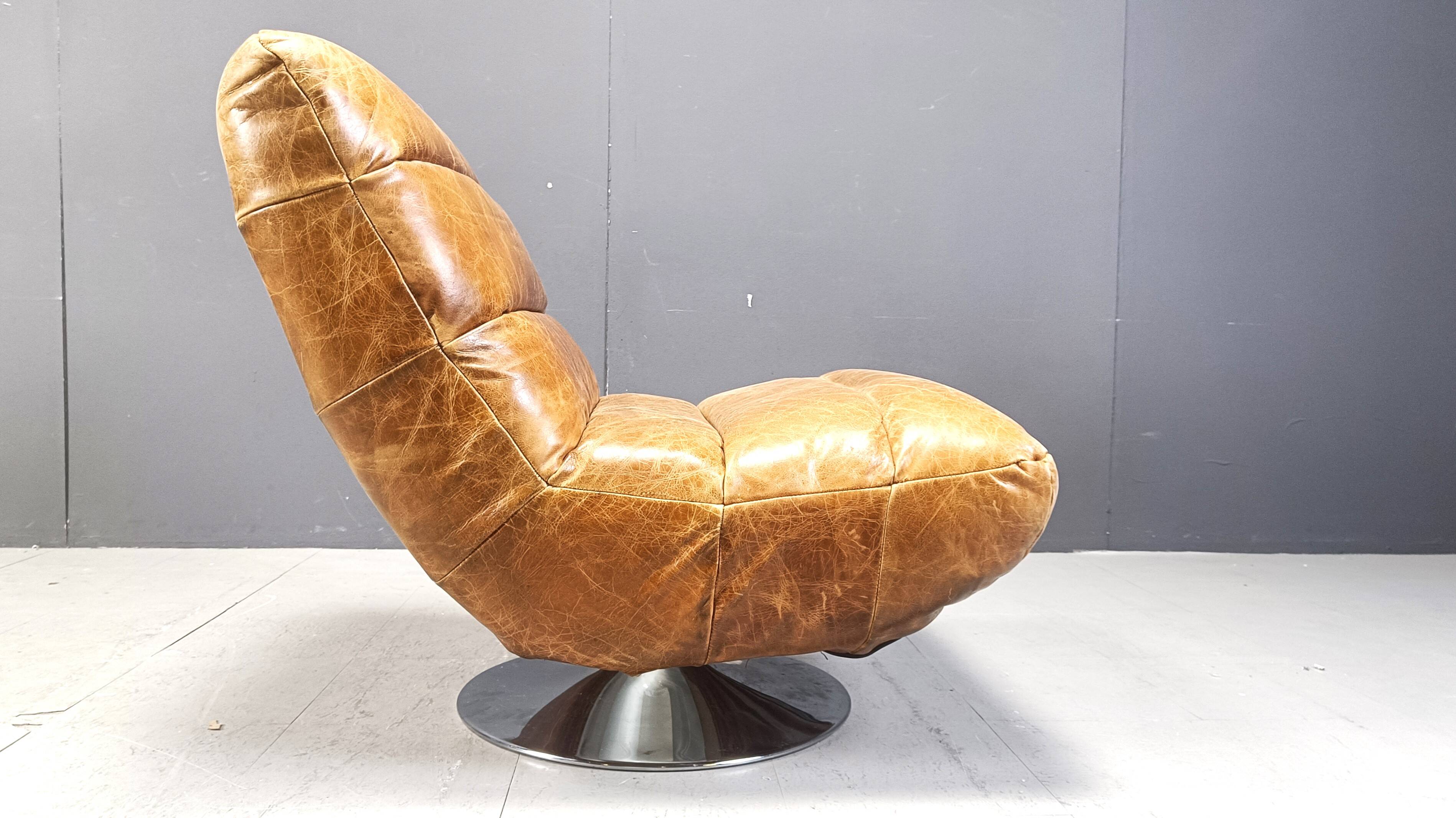 Vintage leather swivel chair with stool, 1970s
