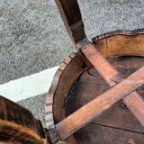 Old wooden saddle pedestal table with claw feet