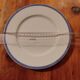 Limoges porcelain plate with a blue speckled rim.