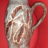 Pitcher in varnished snarl, grey-blue background. Signed.