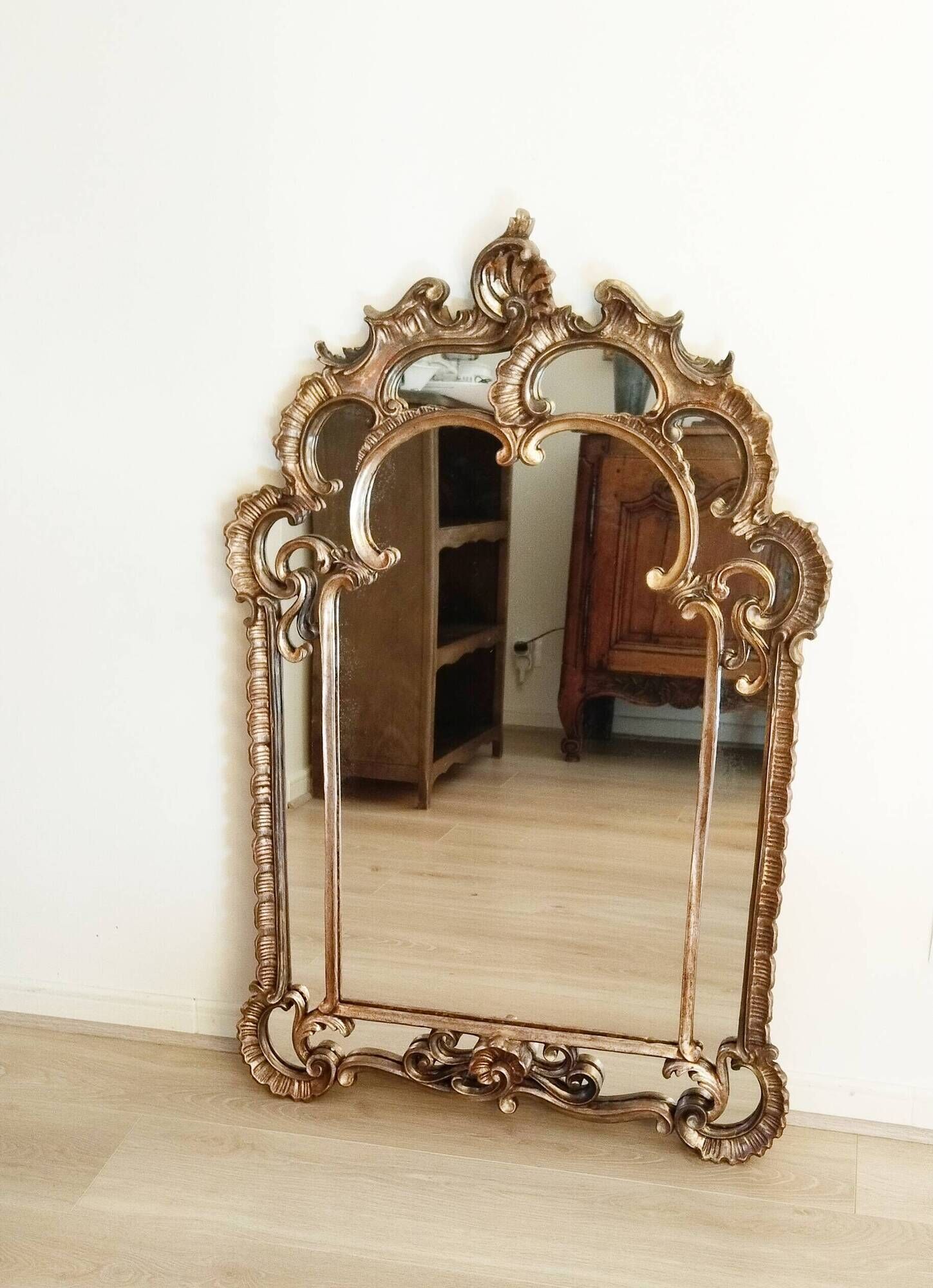 Antique mirror with rococo-style pareclose, in gilded wood, 19th century
