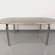 Vintage oval dining table in smoked glass and chrome metal, Space Age style.