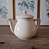 Vintage round ceramic teapot in cream colour, art deco style.