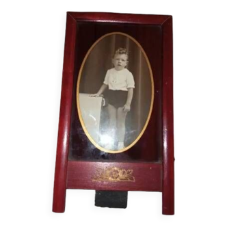 Old frame and photo from the 1930s. Vintage child