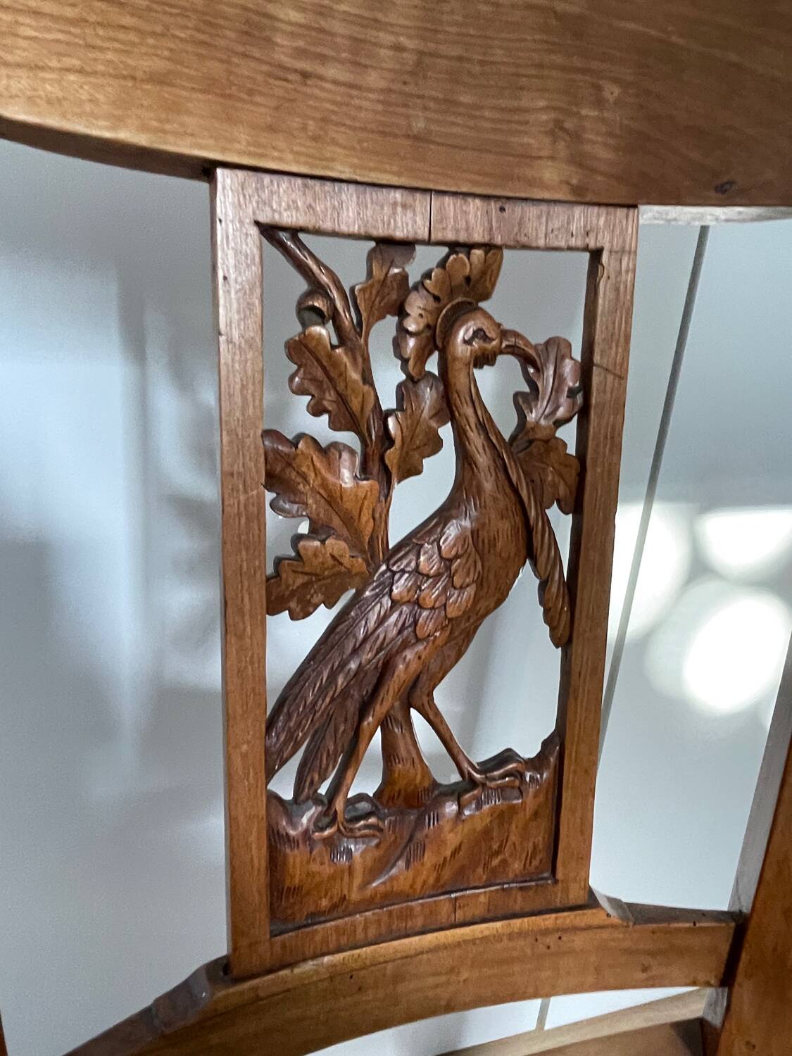 19th century straw chair with carved peacock back