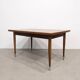 Vintage extendable dining table with tapered legs.