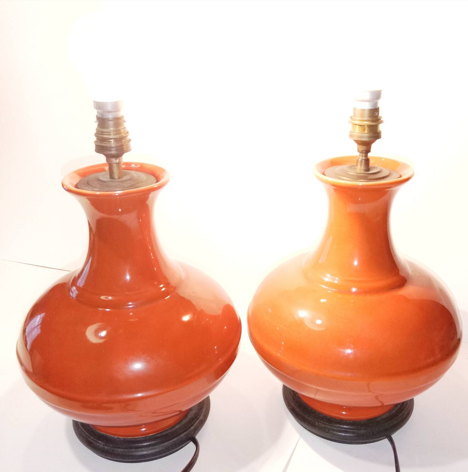 Pair of ceramic lamp bases in the shape of orange gourds.
