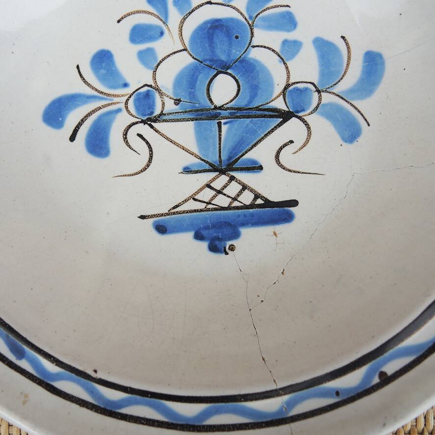 Old large round black ceramic dish
