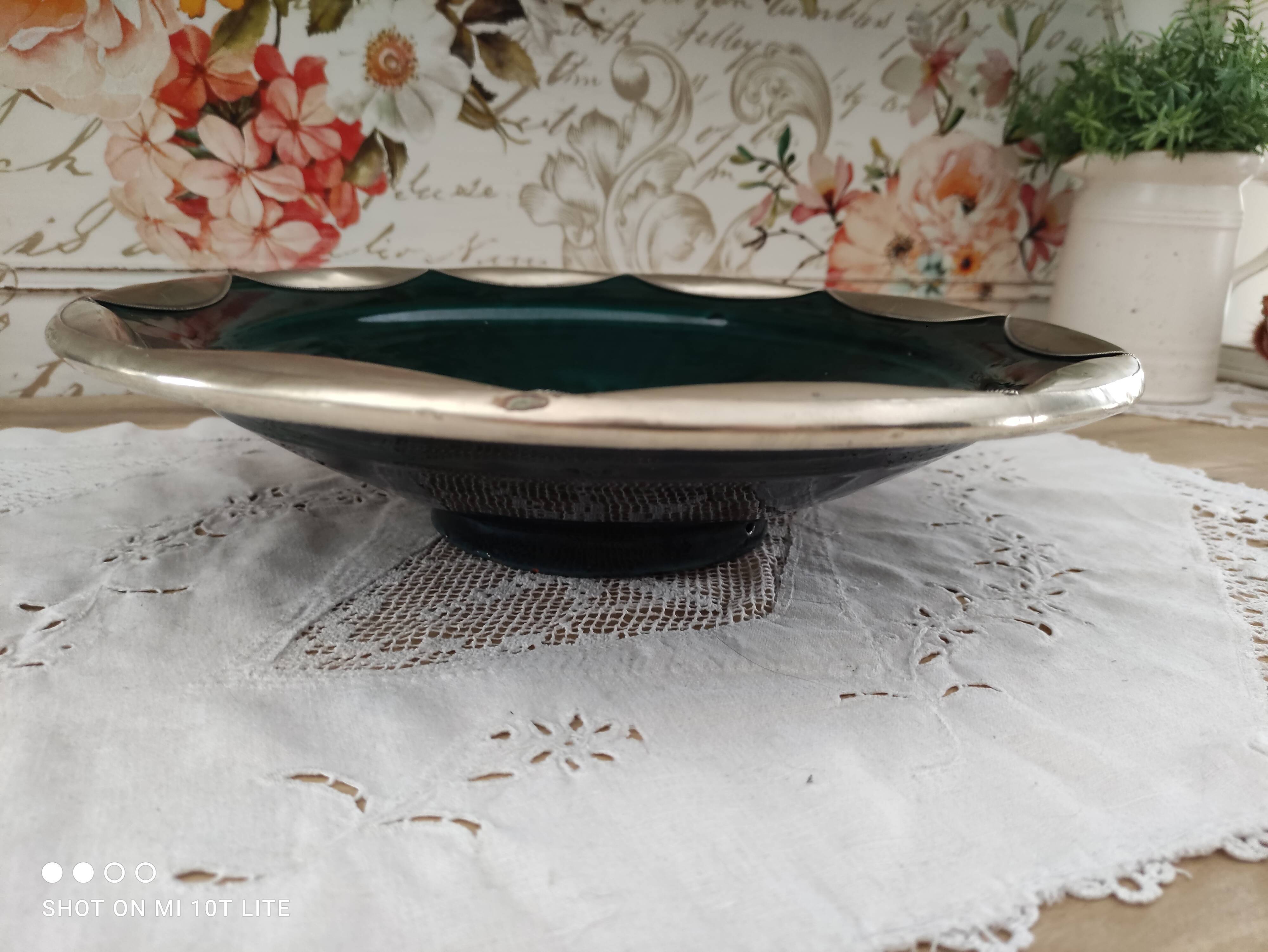 Round oriental hollow dish in deep green ceramic and silver colored metal